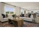 Open concept living room with modern furnishings, hardwood floors, and an adjacent dining room at 100 Reagan Crest Dr, Clayton, NC 27520