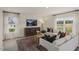 Bright living room with hardwood floors, large windows, comfortable seating and stylish decor at 100 Reagan Crest Dr, Clayton, NC 27520