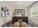 Bright, staged office featuring a desk, artwork, stools, shelves, and a large window at 100 Reagan Crest Dr, Clayton, NC 27520