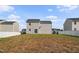 Exterior view of backyard, showcasing the privacy fence and home's rear facade at 1004 Summer Mist Ln, Durham, NC 27704