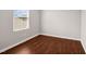 This bedroom features hardwood floors and a window providing ample natural light at 1004 Summer Mist Ln, Durham, NC 27704