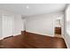 A bedroom featuring wood floors and an open doorway to the ensuite bathroom at 1004 Summer Mist Ln, Durham, NC 27704