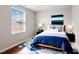 A beautifully staged bedroom features a large bed, modern decor, and bright natural light at 1004 Summer Mist Ln, Durham, NC 27704