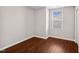 This empty bedroom has hardwood floors and a window offering natural light at 1004 Summer Mist Ln, Durham, NC 27704