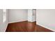 Empty bedroom featuring hardwood floors, neutral walls, and ample closet space at 1004 Summer Mist Ln, Durham, NC 27704