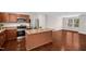 Bright kitchen featuring stainless steel appliances, a center island, and wood cabinets at 1004 Summer Mist Ln, Durham, NC 27704