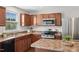 Close up on the kitchen with stainless steel appliances, double sink, and granite countertops at 1004 Summer Mist Ln, Durham, NC 27704