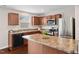 Spacious kitchen with stainless steel appliances, granite counters, and wood cabinets at 1004 Summer Mist Ln, Durham, NC 27704