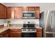 Kitchen featuring stainless steel appliances, granite countertops and wood cabinets at 1004 Summer Mist Ln, Durham, NC 27704