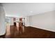 Open concept living area featuring dark wood floors connecting kitchen and living room at 1004 Summer Mist Ln, Durham, NC 27704
