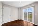 Empty room with light gray walls, door, and sliding glass door at 1004 Summer Mist Ln, Durham, NC 27704
