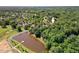 An aerial view showcases a community by a tranquil lake and wooded landscape at 104 Cedar Ridge Way, Durham, NC 27705