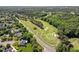 Aerial view showcases this neighborhood's golf course and green, tree-filled surroundings at 104 Cedar Ridge Way, Durham, NC 27705