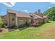 Stunning brick home with a spacious wooden deck and lush green lawn at 104 Cedar Ridge Way, Durham, NC 27705