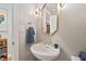 Charming powder room with a pedestal sink, gold fixtures, and decorative mirror at 104 Cedar Ridge Way, Durham, NC 27705