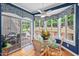 Bright breakfast nook features hardwood floors, large windows, and a view to the deck and backyard at 104 Cedar Ridge Way, Durham, NC 27705