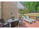 Inviting outdoor deck with comfortable lounge chairs, a dining table, and scenic views of the wooded surroundings at 104 Cedar Ridge Way, Durham, NC 27705