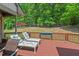Relaxing deck area with lounge seating, overlooking a lush, green backyard and mature trees at 104 Cedar Ridge Way, Durham, NC 27705