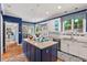 Spacious kitchen with an island cooktop, white cabinets, and bright breakfast nook area at 104 Cedar Ridge Way, Durham, NC 27705