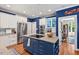 Well-equipped kitchen with stainless steel appliances, an island cooktop, and white cabinetry at 104 Cedar Ridge Way, Durham, NC 27705