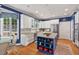 Stylish kitchen features white cabinets, stainless steel appliances, and a center island with granite countertops at 104 Cedar Ridge Way, Durham, NC 27705