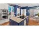 Well-equipped kitchen with stainless steel appliances, an island cooktop, and white cabinetry at 104 Cedar Ridge Way, Durham, NC 27705