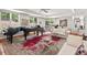 Sophisticated living room with two pianos and an outdoor view at 104 Cedar Ridge Way, Durham, NC 27705