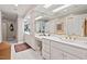 Bright bathroom with double vanity, white cabinets, and large mirrors at 104 Cedar Ridge Way, Durham, NC 27705