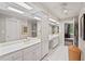 Bright bathroom with double vanity, white cabinets, and large mirrors at 104 Cedar Ridge Way, Durham, NC 27705