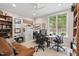 Bright home office featuring a ceiling fan, ample natural light, and built-in shelving for a productive workspace at 104 Cedar Ridge Way, Durham, NC 27705