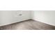 Bedroom with wood-look flooring, white trim and baseboards, and a window at 107 Altair Ln, Sanford, NC 27330
