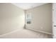 Neutral bedroom features a large window and neutral carpeting at 107 Altair Ln, Sanford, NC 27330