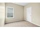 A bright, airy bedroom features neutral carpeting and a window at 107 Altair Ln, Sanford, NC 27330