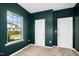 This carpeted bedroom features two white doors and a window at 107 Altair Ln, Sanford, NC 27330