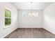Bright dining room with a modern light fixture and large window, ideal for Gathering meals at 107 Altair Ln, Sanford, NC 27330