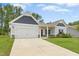 Charming single Gathering home with a two-car garage, stone accents, and well-manicured lawn at 107 Altair Ln, Sanford, NC 27330