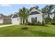 Exterior shot showing the landscaped yard, siding, and trim details of this single-Gathering home at 107 Altair Ln, Sanford, NC 27330