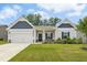 Charming single-Gathering home with a well-manicured lawn, attached garage, and inviting entrance at 107 Altair Ln, Sanford, NC 27330