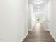 Bright hallway with modern flooring leading into the open living area, enhancing the home's flow at 107 Altair Ln, Sanford, NC 27330