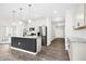 Open-concept kitchen with stainless appliances, granite counters, and white cabinetry at 107 Altair Ln, Sanford, NC 27330