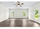 Bright, airy living room with modern flooring and a ceiling fan, offering a comfortable living space at 107 Altair Ln, Sanford, NC 27330