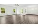 Spacious living room featuring ample natural light, wood-look floors, and modern ceiling fan at 107 Altair Ln, Sanford, NC 27330