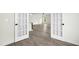 An open concept room with wood-look flooring, white trim and a ceiling fan at 107 Altair Ln, Sanford, NC 27330