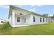 Exterior view of covered patio with ceiling fan, outdoor lighting, and a grassy backyard at 107 Altair Ln, Sanford, NC 27330