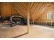 Unfinished attic space with exposed wooden beams, providing potential for customization at 10909 Grand Journey Ave, Raleigh, NC 27614
