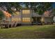 Exterior of a two-story home with a wooden deck and screened in porch at sunset at 10909 Grand Journey Ave, Raleigh, NC 27614