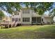 Two-story home featuring a wooden deck, screened porch, and a well-manicured lawn at 10909 Grand Journey Ave, Raleigh, NC 27614