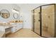 Spacious bathroom featuring a glass-enclosed shower, granite counters, and modern lighting at 10909 Grand Journey Ave, Raleigh, NC 27614