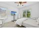 Bright bedroom with a flat screen TV, natural light, and neutral tones at 10909 Grand Journey Ave, Raleigh, NC 27614