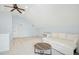 Bright bonus room with light blue walls, built-in shelves, and a white sofa at 10909 Grand Journey Ave, Raleigh, NC 27614